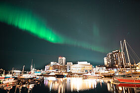 Northern lights above Tromso's harbour